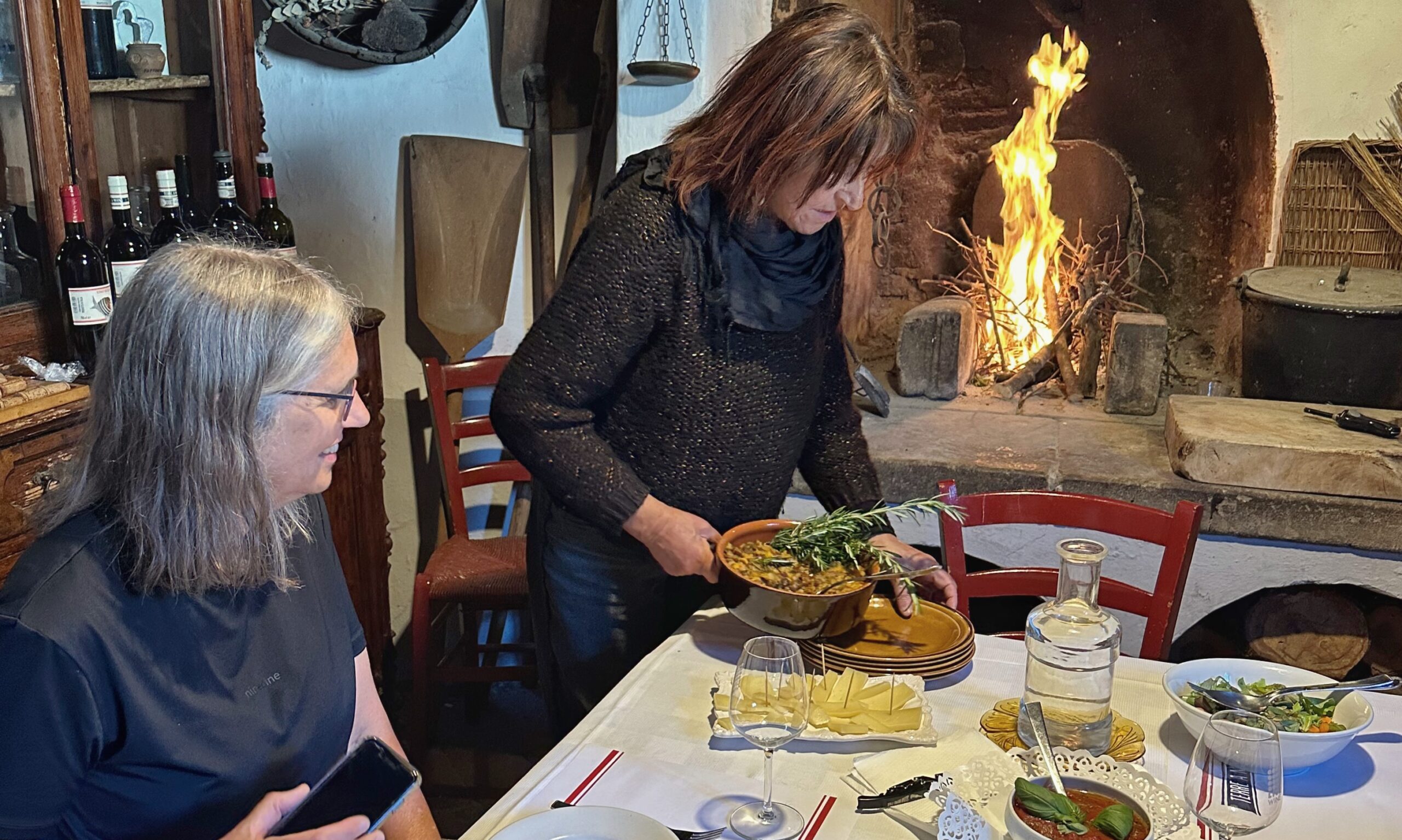 Homemade Tuscan lunch served by the fireplace during a private wine tour at a family-run winery in Tuscany.